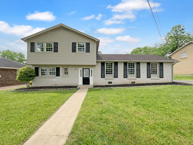 tri-level home featuring a front lawn, brick siding, and roof with shingles