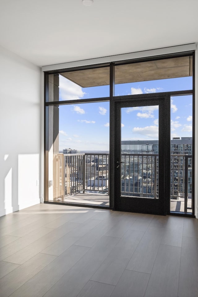 spare room featuring expansive windows and a city view