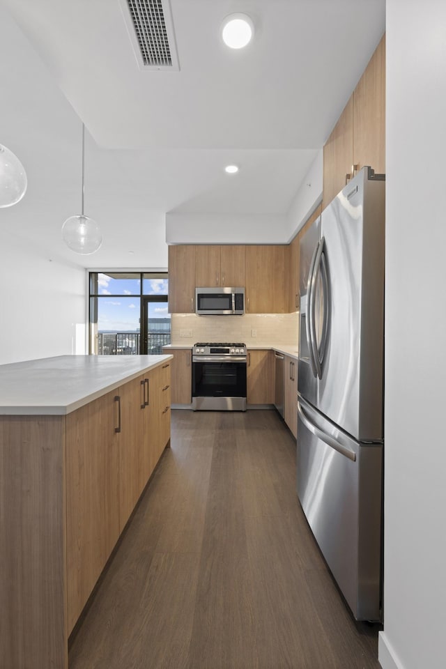 kitchen featuring stainless steel appliances, dark wood-style floors, light countertops, and modern cabinets
