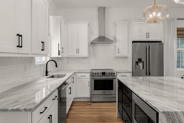 5615 Tennessee Ave Unit A, Nashville, TN 37209 - kitchen featuring appliances with stainless steel finishes, wall chimney exhaust hood, a sink, white cabinets, and light stone counters