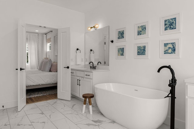5615 Tennessee Ave Unit A, Nashville, TN 37209 - ensuite bathroom with marble look tiles, vanity, a freestanding tub, and baseboards