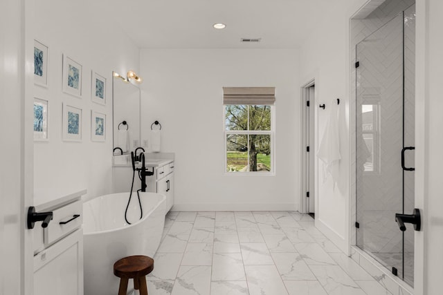 5615 Tennessee Ave Unit A, Nashville, TN 37209 - bathroom featuring marble look tiles, a shower stall, recessed lighting, a freestanding bath, and baseboards