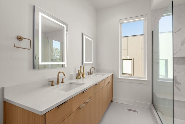 1400 Arthur Ave Unit 3, Nashville, TN 37208 - full bathroom with double vanity, baseboards, a marble finish shower, and tile patterned flooring