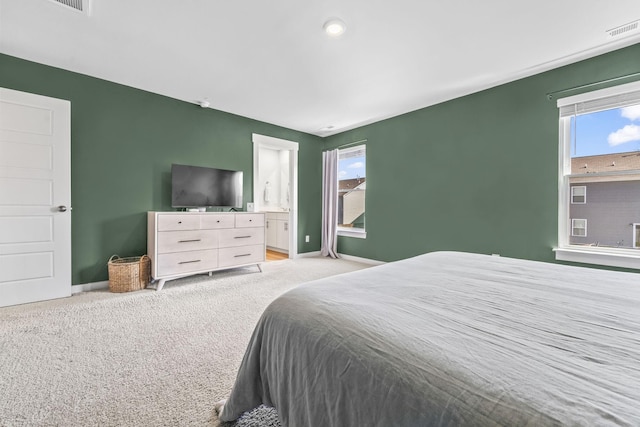 bedroom with light carpet and baseboards
