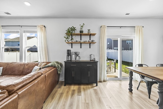 living area featuring light wood-style flooring and recessed lighting