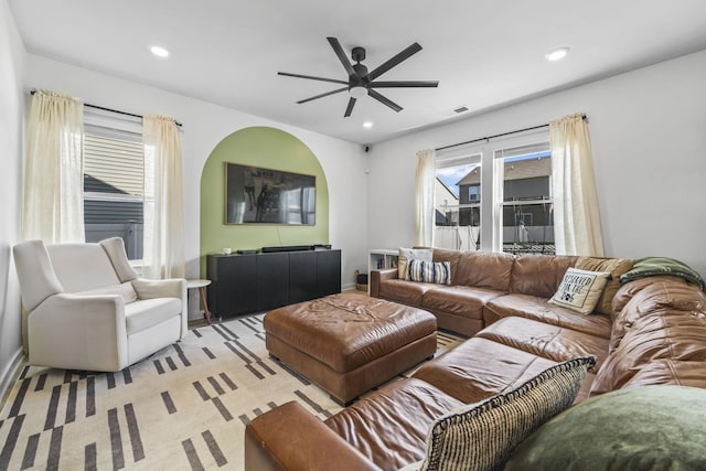 living area with ceiling fan, plenty of natural light, recessed lighting, and baseboards