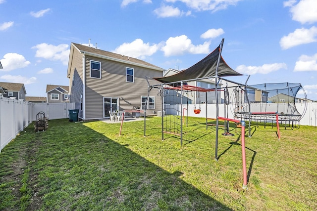 back of property featuring a trampoline and a playground