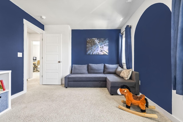 living area featuring carpet floors and baseboards