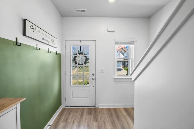 entryway featuring wood finished floors and baseboards