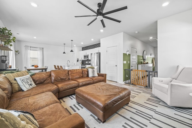 living room featuring a ceiling fan and recessed lighting