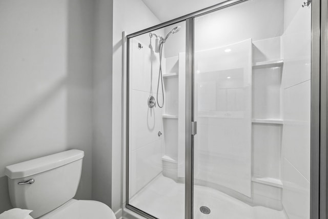 bathroom with toilet and a stall shower