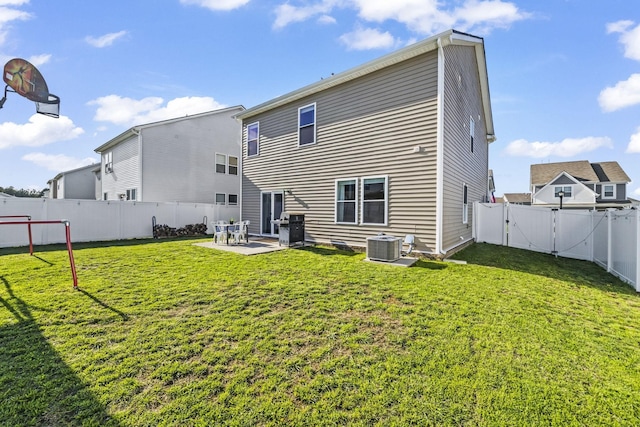 rear view of house with a gate, a patio, and central AC