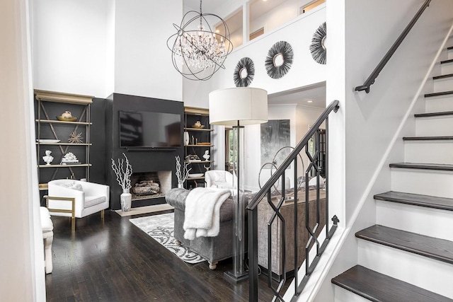 716 Split Rail Dr, Brentwood, TN 37027 - stairs featuring a high ceiling, wood finished floors, a chandelier, and a fireplace