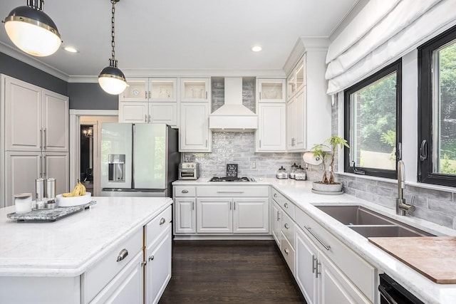 716 Split Rail Dr, Brentwood, TN 37027 - kitchen with wall chimney exhaust hood, a sink, stainless steel fridge with ice dispenser, white cabinets, and ornamental molding
