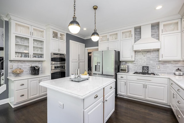 716 Split Rail Dr, Brentwood, TN 37027 - kitchen with wall chimney exhaust hood, refrigerator with ice dispenser, gas cooktop, a center island, and decorative backsplash