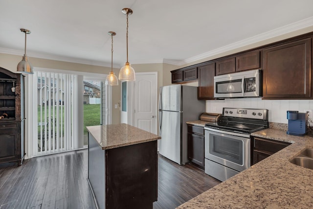 127 Cobblestone Place Dr, Goodlettsville, TN 37072 - kitchen featuring appliances with stainless steel finishes, dark brown cabinetry, dark wood finished floors, light stone countertops, and ornamental molding