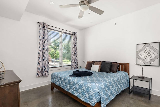 bedroom with concrete floors, baseboards, and ceiling fan