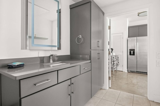 bathroom featuring tile patterned flooring and vanity