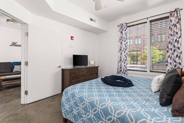 bedroom with finished concrete floors and ceiling fan