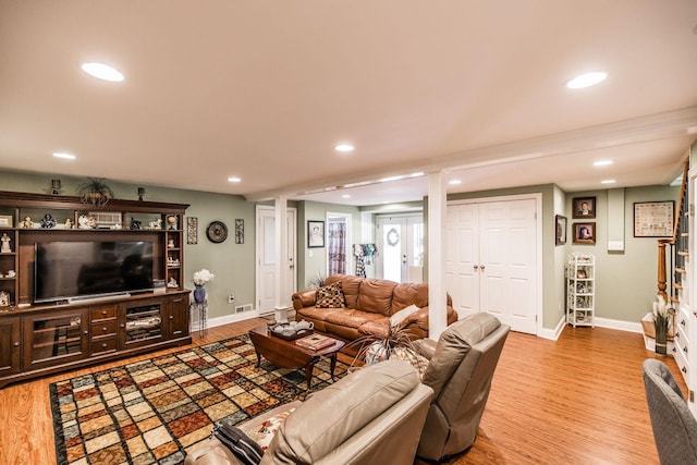 living area featuring wood finished floors, recessed lighting, and baseboards