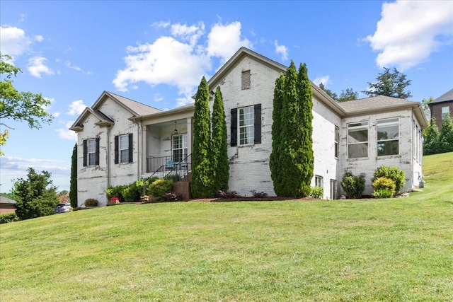 ranch-style house featuring brick siding and a front yard