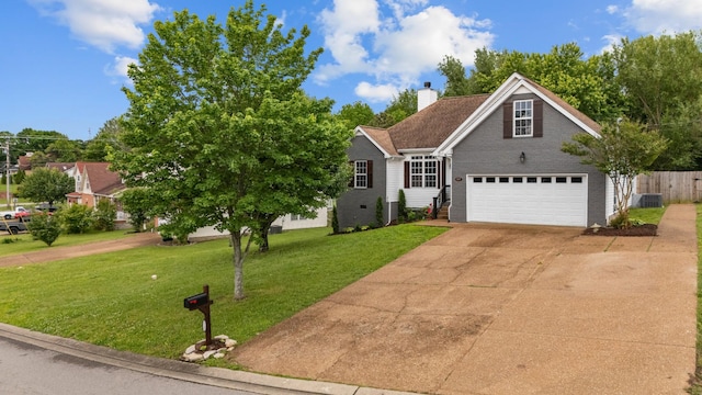 traditional-style home featuring driveway, a chimney, brick siding, a garage, and central AC unit