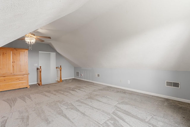 bonus room with baseboards, vaulted ceiling, ceiling fan, and light carpet