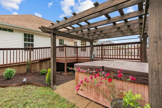 deck featuring a hot tub and a pergola