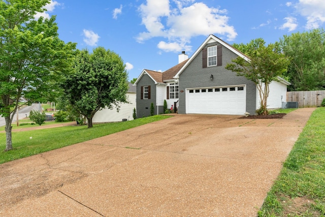 traditional-style house with concrete driveway, a chimney, a garage, and brick siding