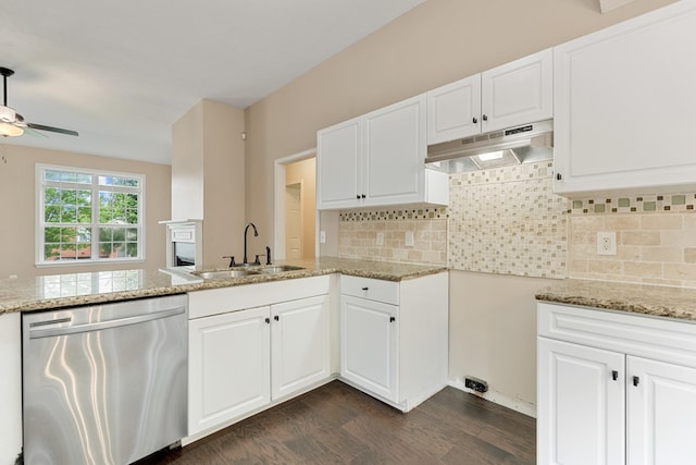 kitchen with dishwasher, a sink, under cabinet range hood, dark wood-type flooring, and light stone countertops