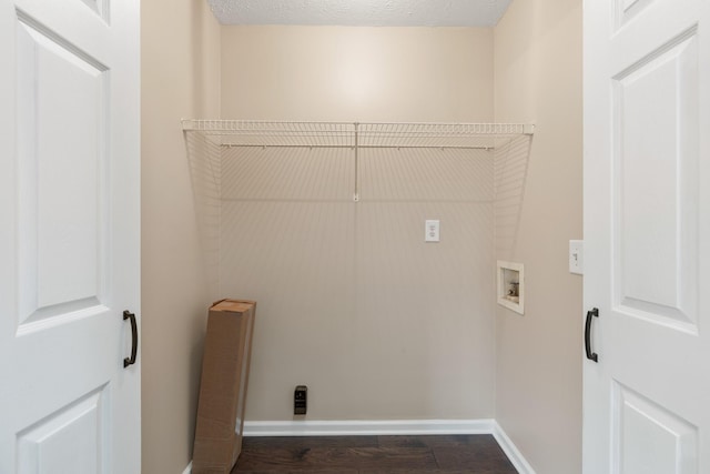 laundry area with washer hookup, baseboards, and dark wood-type flooring