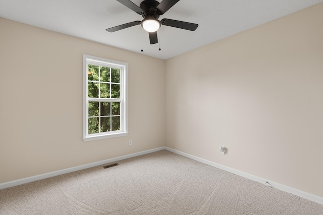 carpeted empty room with baseboards and ceiling fan