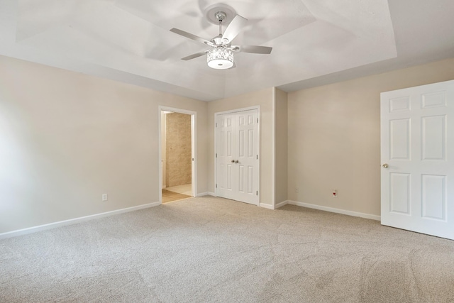 unfurnished bedroom featuring carpet floors, baseboards, a closet, and a ceiling fan