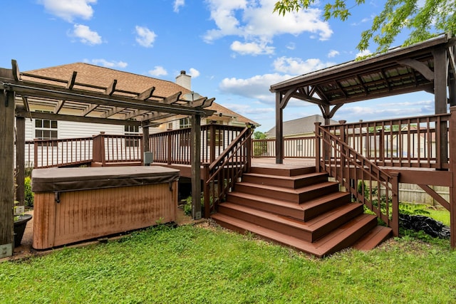deck featuring a hot tub, a pergola, a yard, and stairway