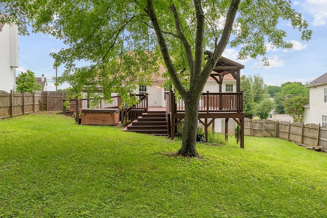 view of yard featuring a hot tub and a deck