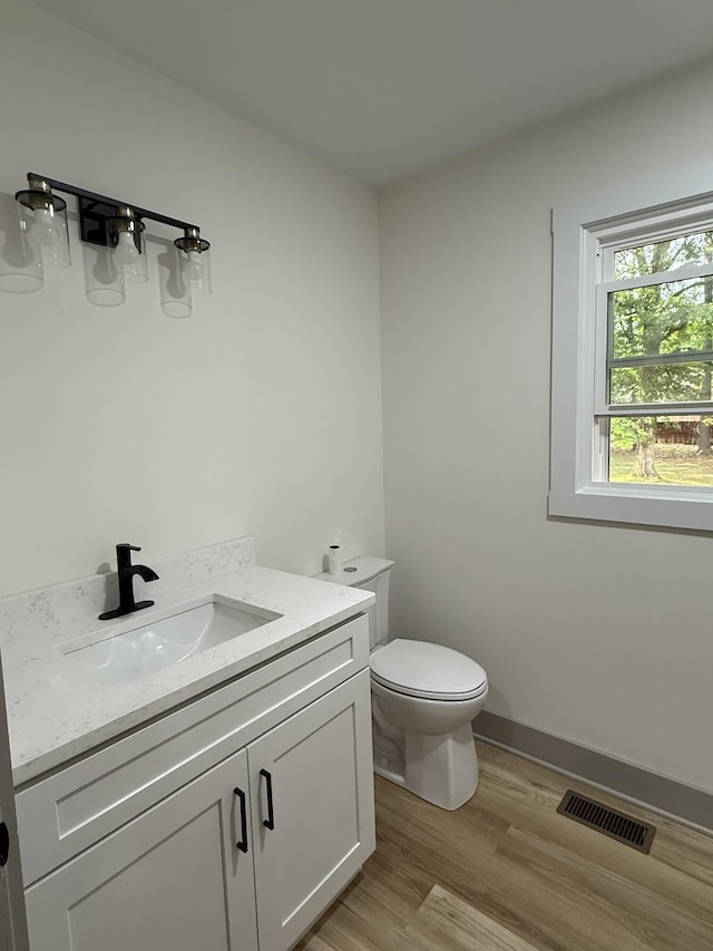 305 Twelve Oaks Rd, Tullahoma, TN 37388 - half bathroom with toilet, vanity, and wood finished floors