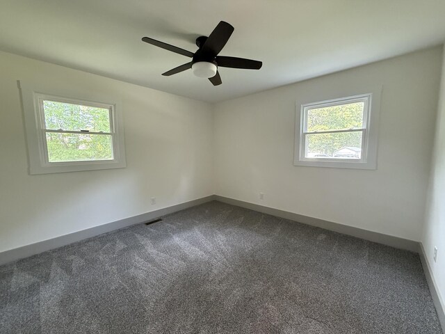305 Twelve Oaks Rd, Tullahoma, TN 37388 - spare room featuring dark colored carpet, baseboards, and a ceiling fan