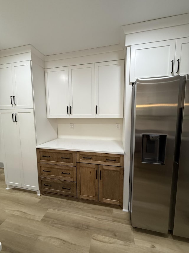 305 Twelve Oaks Rd, Tullahoma, TN 37388 - kitchen featuring stainless steel fridge, light wood-style flooring, and white cabinetry