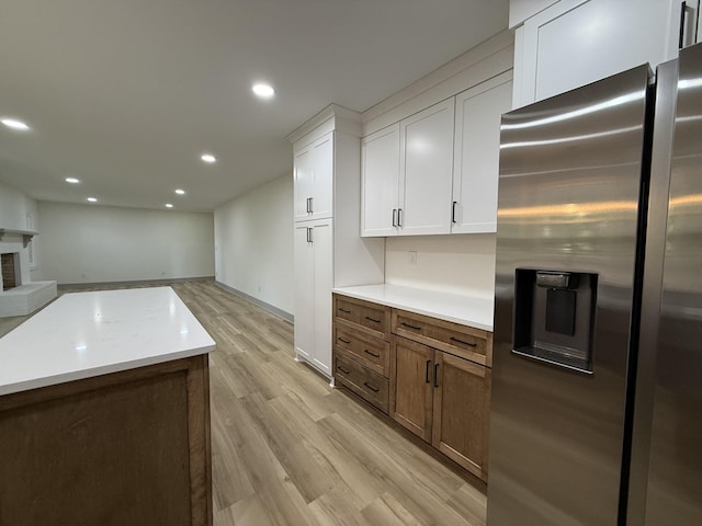 305 Twelve Oaks Rd, Tullahoma, TN 37388 - kitchen featuring stainless steel fridge with ice dispenser, open floor plan, white cabinets, recessed lighting, and light wood-style flooring