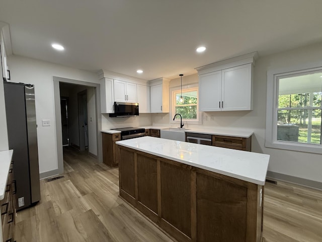 305 Twelve Oaks Rd, Tullahoma, TN 37388 - kitchen with appliances with stainless steel finishes, a sink, light wood-style flooring, white cabinets, and recessed lighting