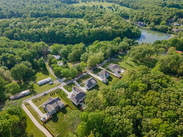 bird's eye view of a heavily wooded area and a nearby body of water