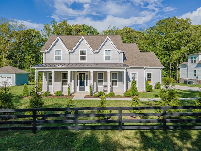 view of front facade featuring a standing seam roof, covered porch, and metal roof