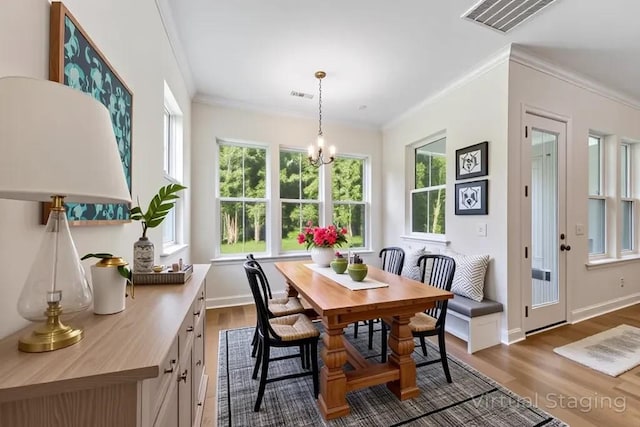 dining space with crown molding, dark wood-style floors, a chandelier, and baseboards