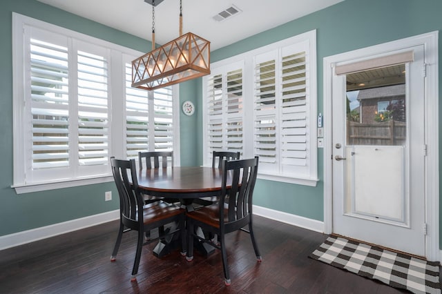 dining area with healthy amount of natural light, baseboards, and dark wood-style floors