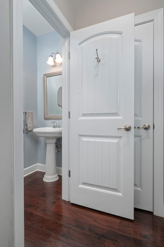 bathroom with wood finished floors and baseboards