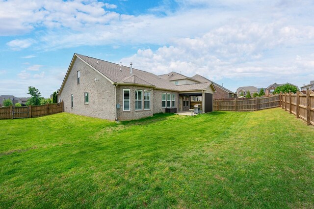 back of house featuring brick siding and a patio