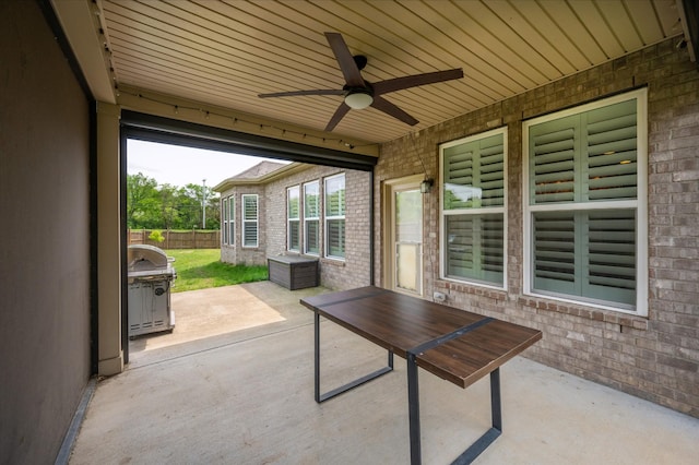 view of patio featuring ceiling fan, a grill, and fence