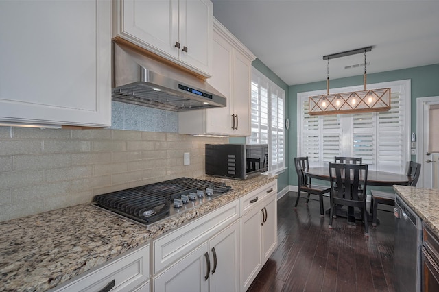 kitchen with appliances with stainless steel finishes, under cabinet range hood, white cabinetry, and dark wood-style flooring