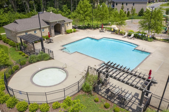 community pool featuring a pergola, fence, and a patio area