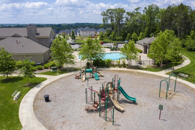 community play area with fence and a residential view